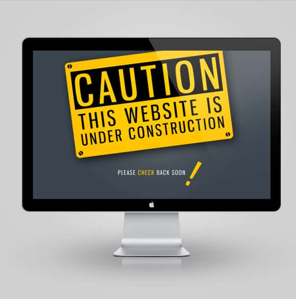 Computer monitor showing a sign that says, "Caution: This website is under construction. Please check back soon."