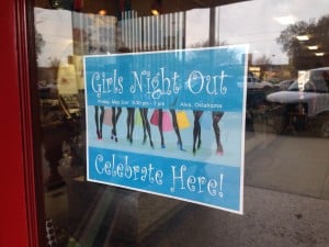 Poster in a store window for a "Girls Night Out" event.