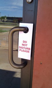 Do not disturb sign on business door. Photo by Becky McCray.