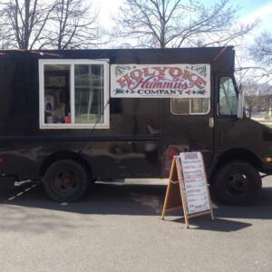 Holyoke Hummus Company truck BEFORE paint with bungee straps holding a banner
