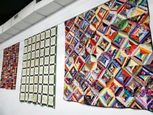 Three quilts on display in early 2020 at Mississippi Cultural Crossroads Port Gibson Mississippi. Photo by Sheila Scarborough.