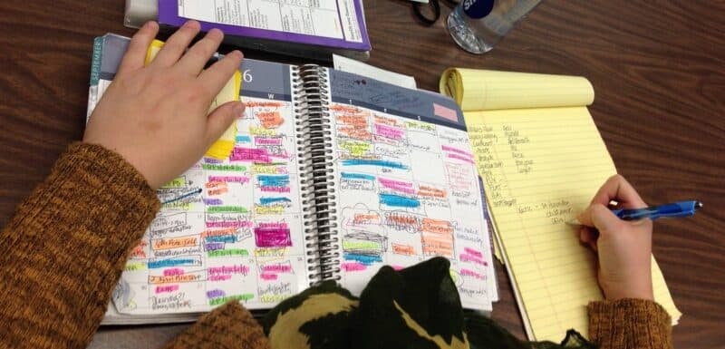 A very busy, full planner with many notes, highlights and scribbles.