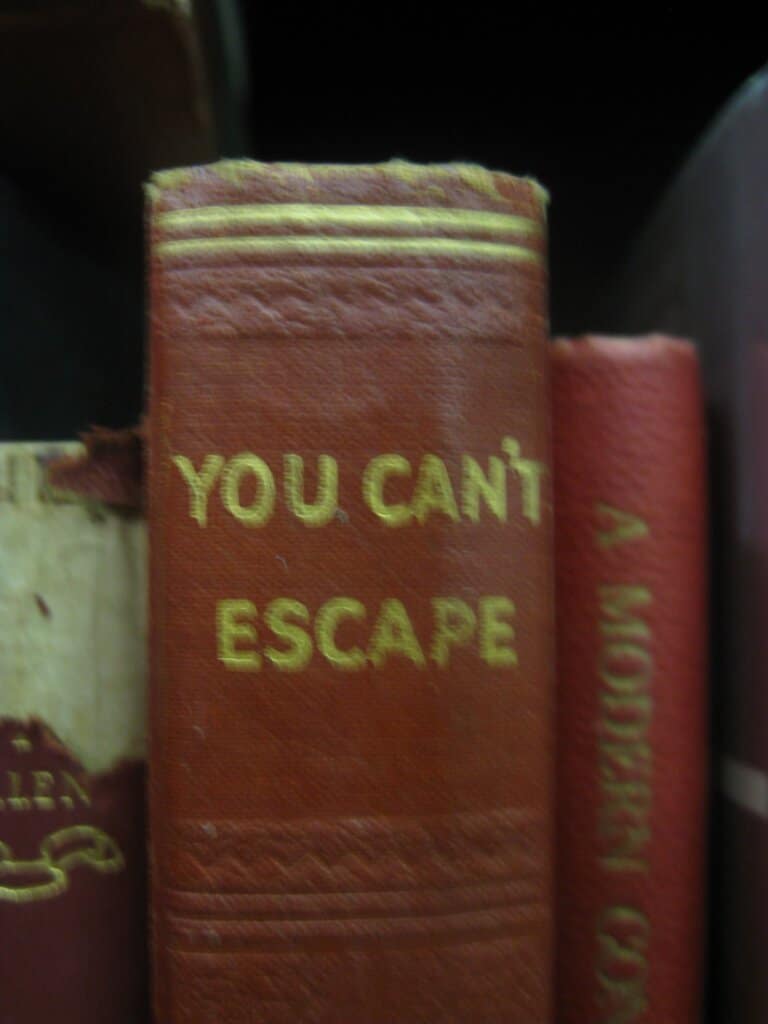 An old book spine says, "You can't escape"