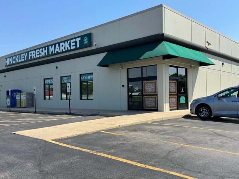 New one-story cement building with signage Hinkley Fresh Market. glass entry doors that open when you approach on the right, three windows on the left with signage in them. 2 Handicapped Parking spots in front of the building. Other parking to the right. Neat and clean appearance.
